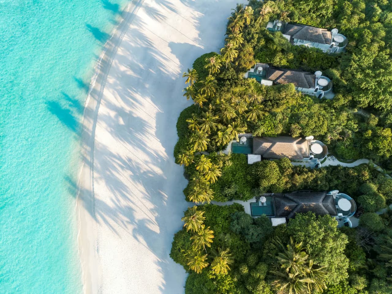 Beach villas beside the white sand beach, aerial view at Anantara Kihavah