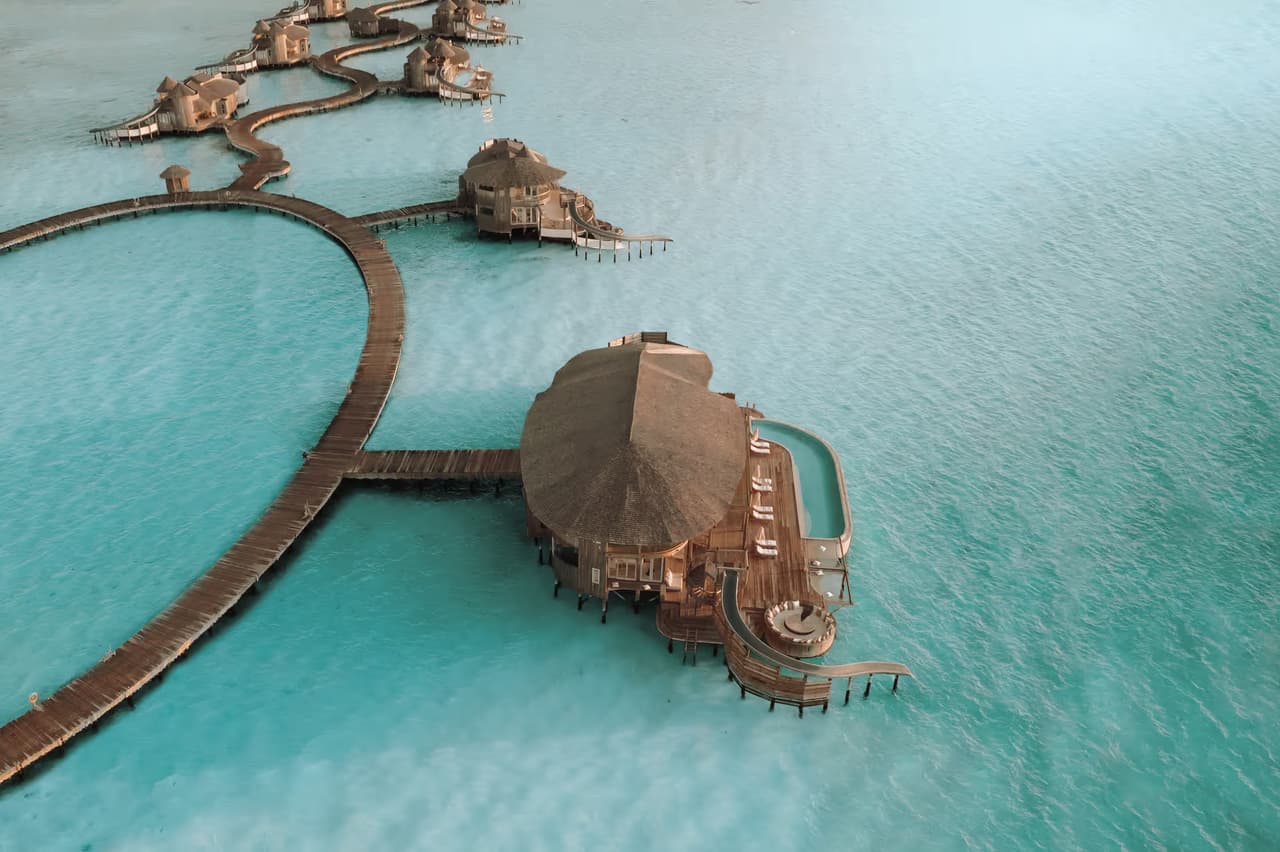 Overwater villas and winding jetty, aerial view at Soneva Jani
