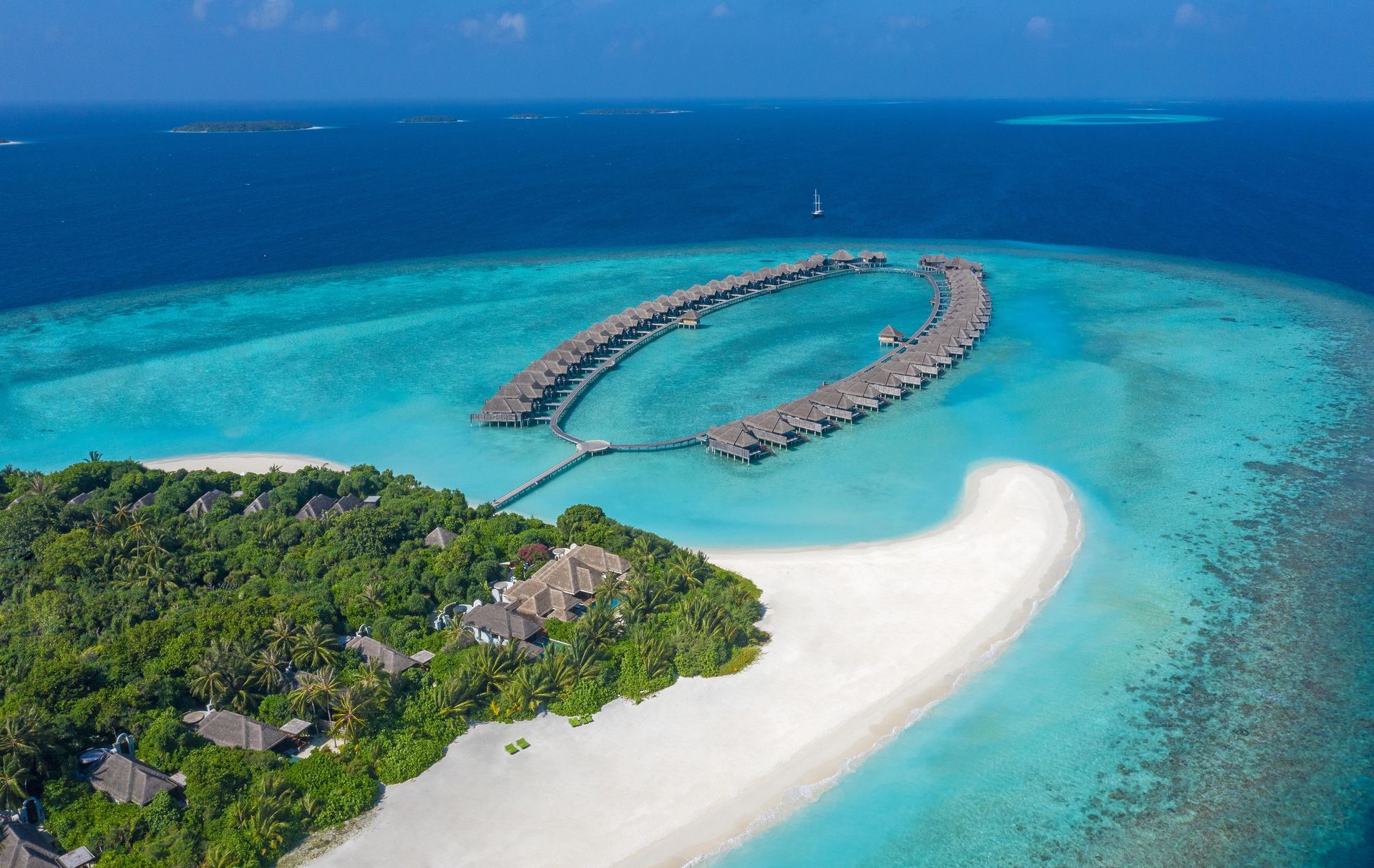 Overwater villas and sandbank aerial view at Anantara Kihavah