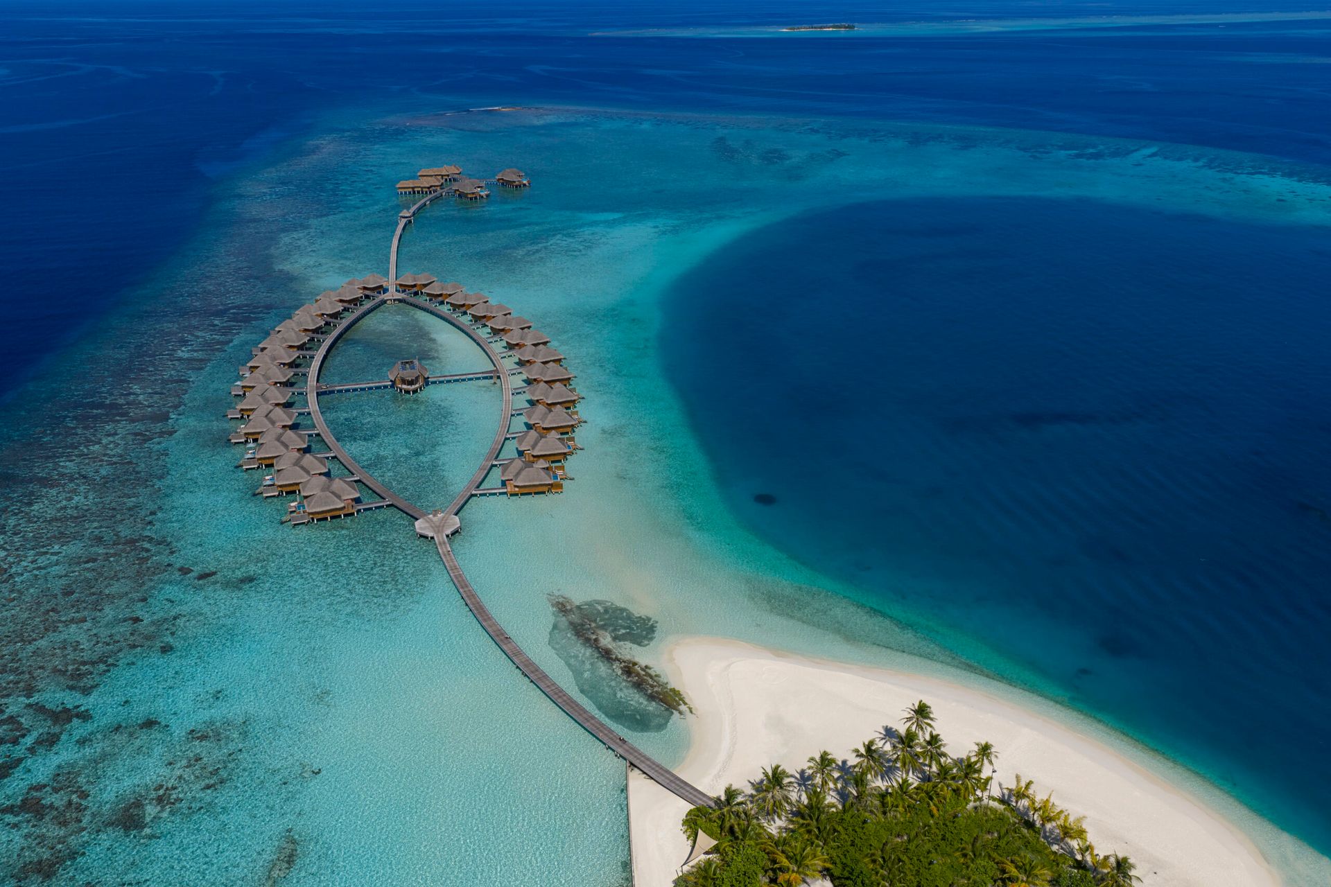 Circular water-villa jetty and sandbank, aerial view at Huvafen Fushi
