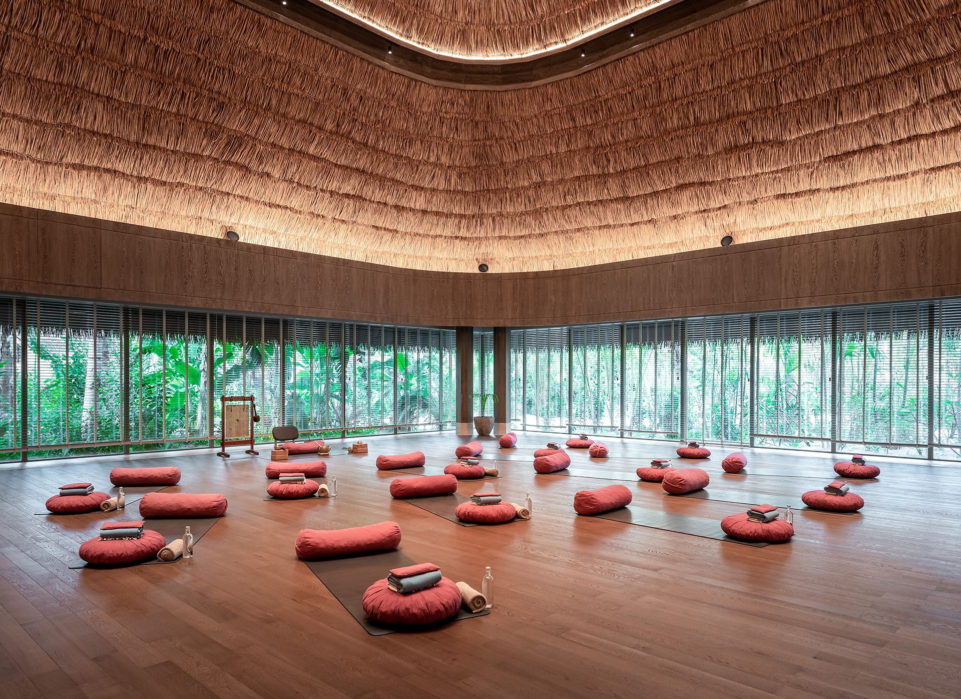 Circular yoga studio with floor cushions at Joali Being