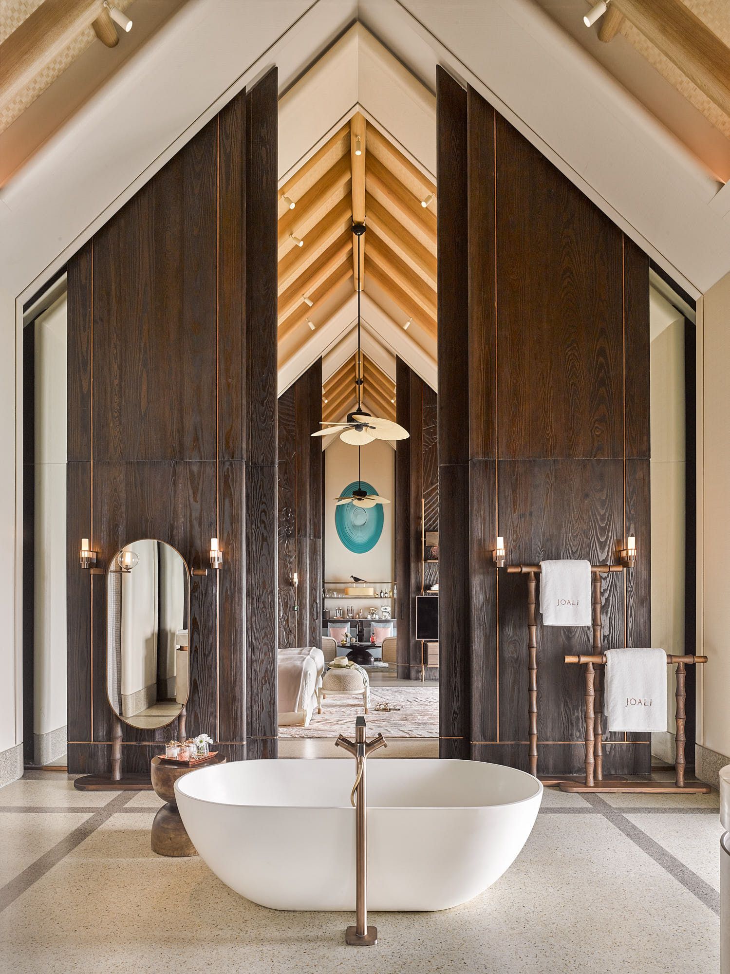 Water villa bathroom with freestanding bathtub at Joali Maldives