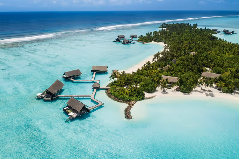 Island shoreline and overwater villas, aerial view at One&Only Reethi Rah