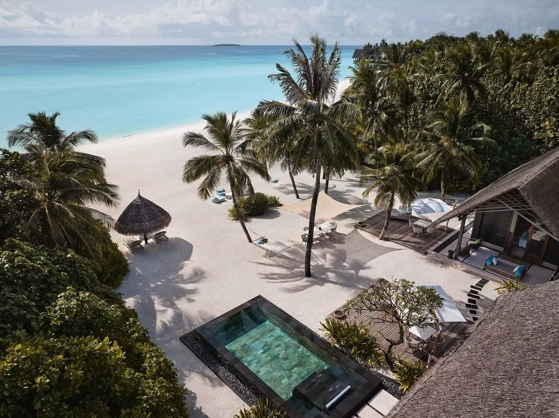 Residence pool and palm-lined beach at One&Only Reethi Rah