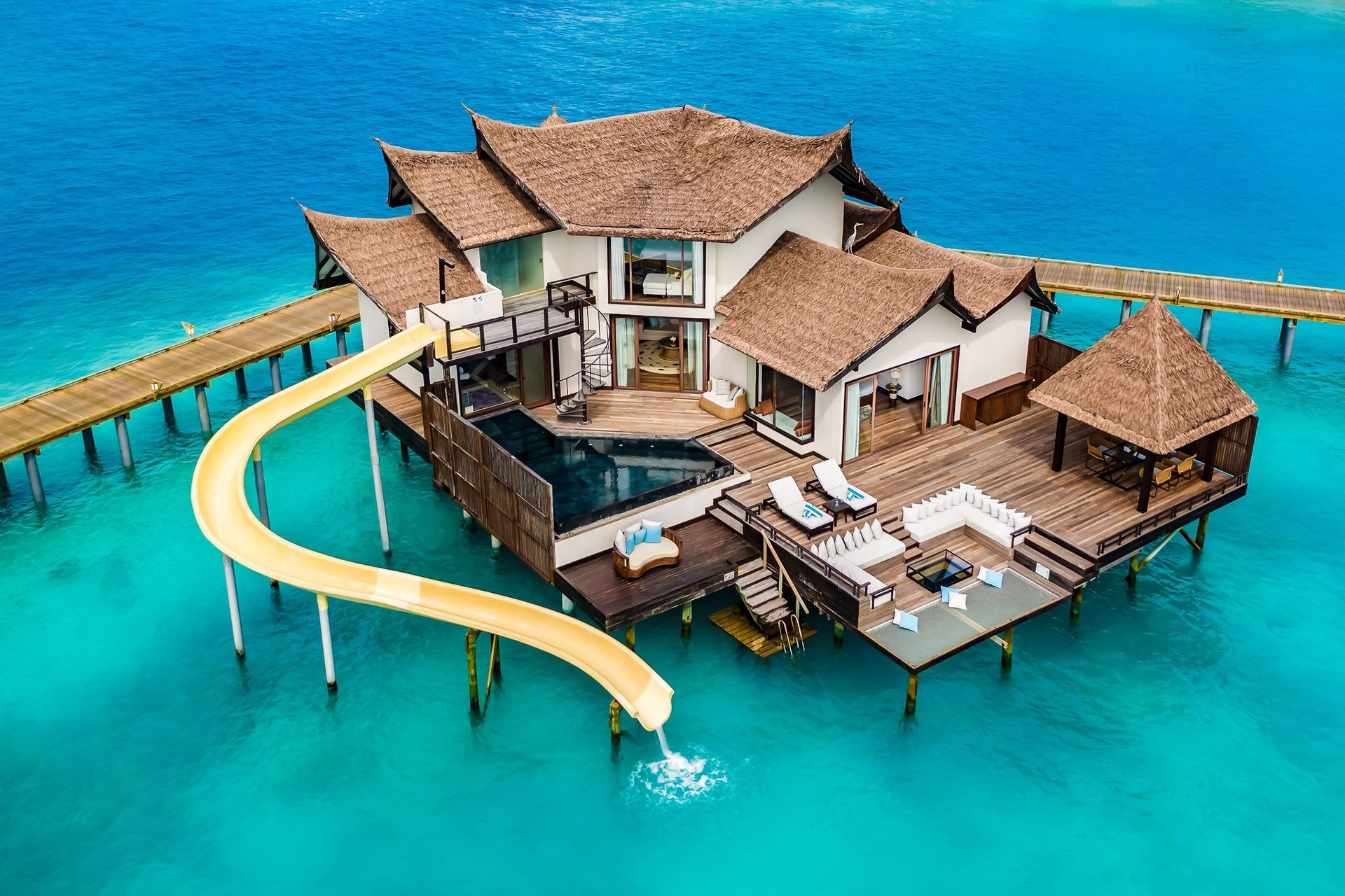 Overwater villa with pool and slide at Ozen Reserve Bolifushi