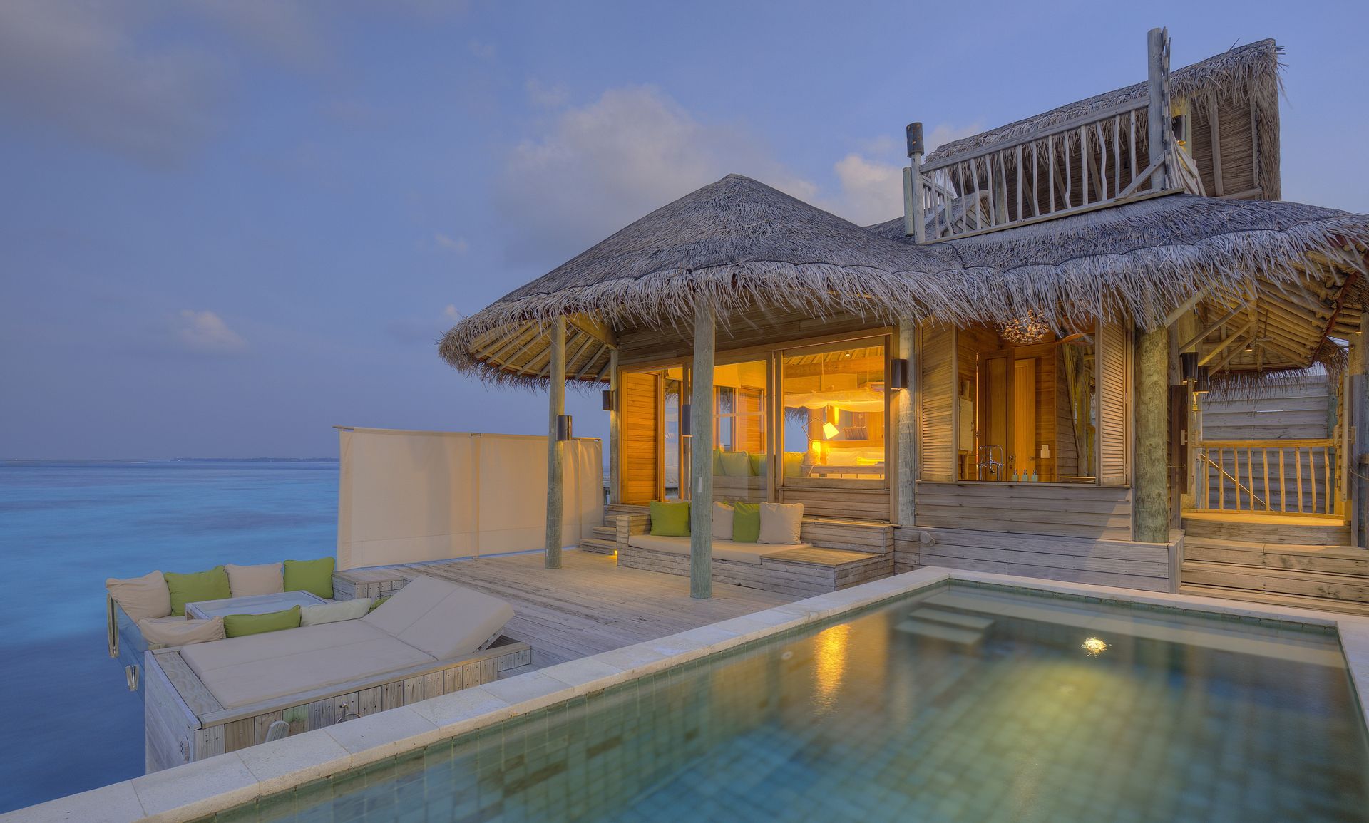 Water villa pool at dusk at Six Senses Laamu