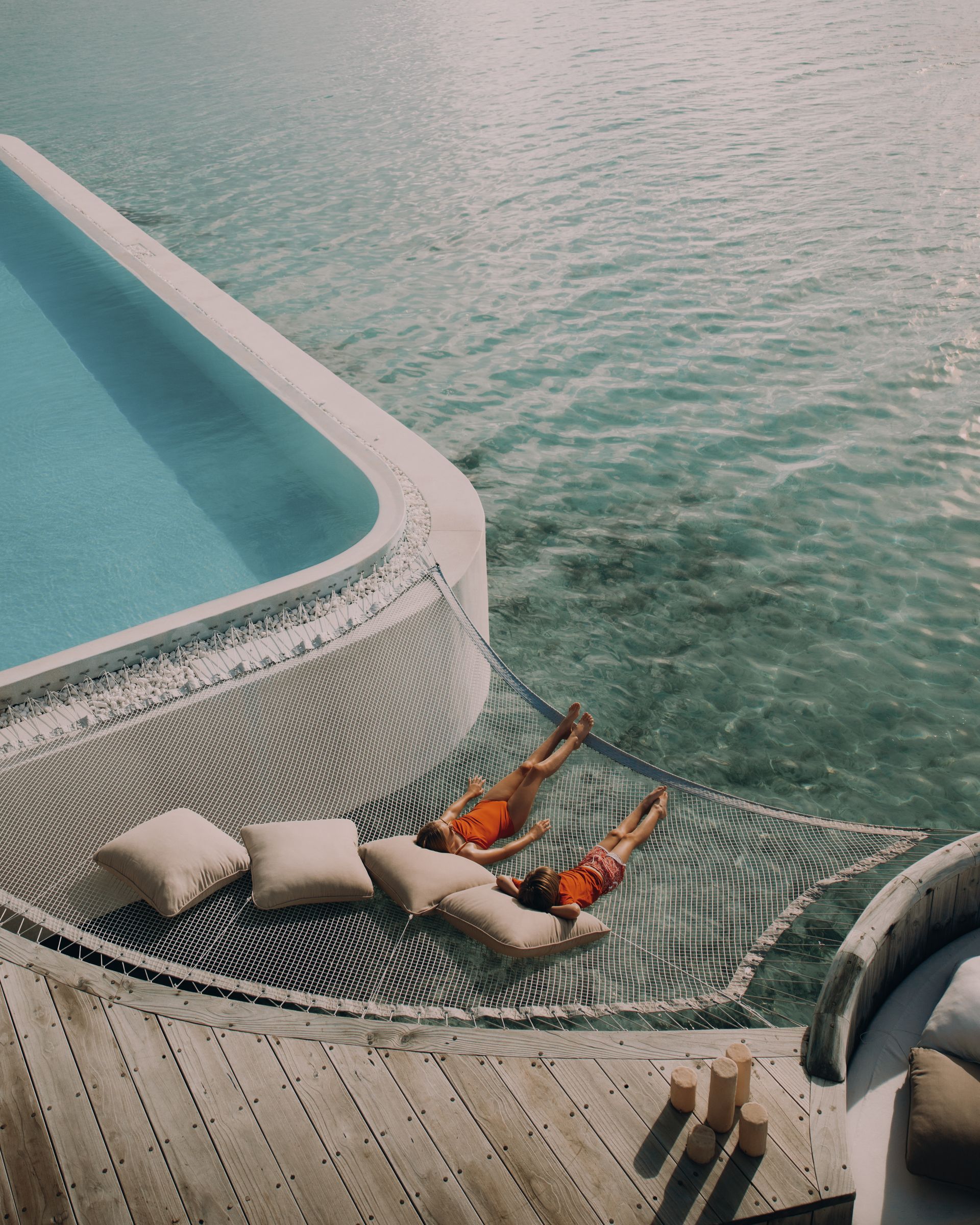 Poolside sun lounger overlooking the lagoon at Soneva Jani