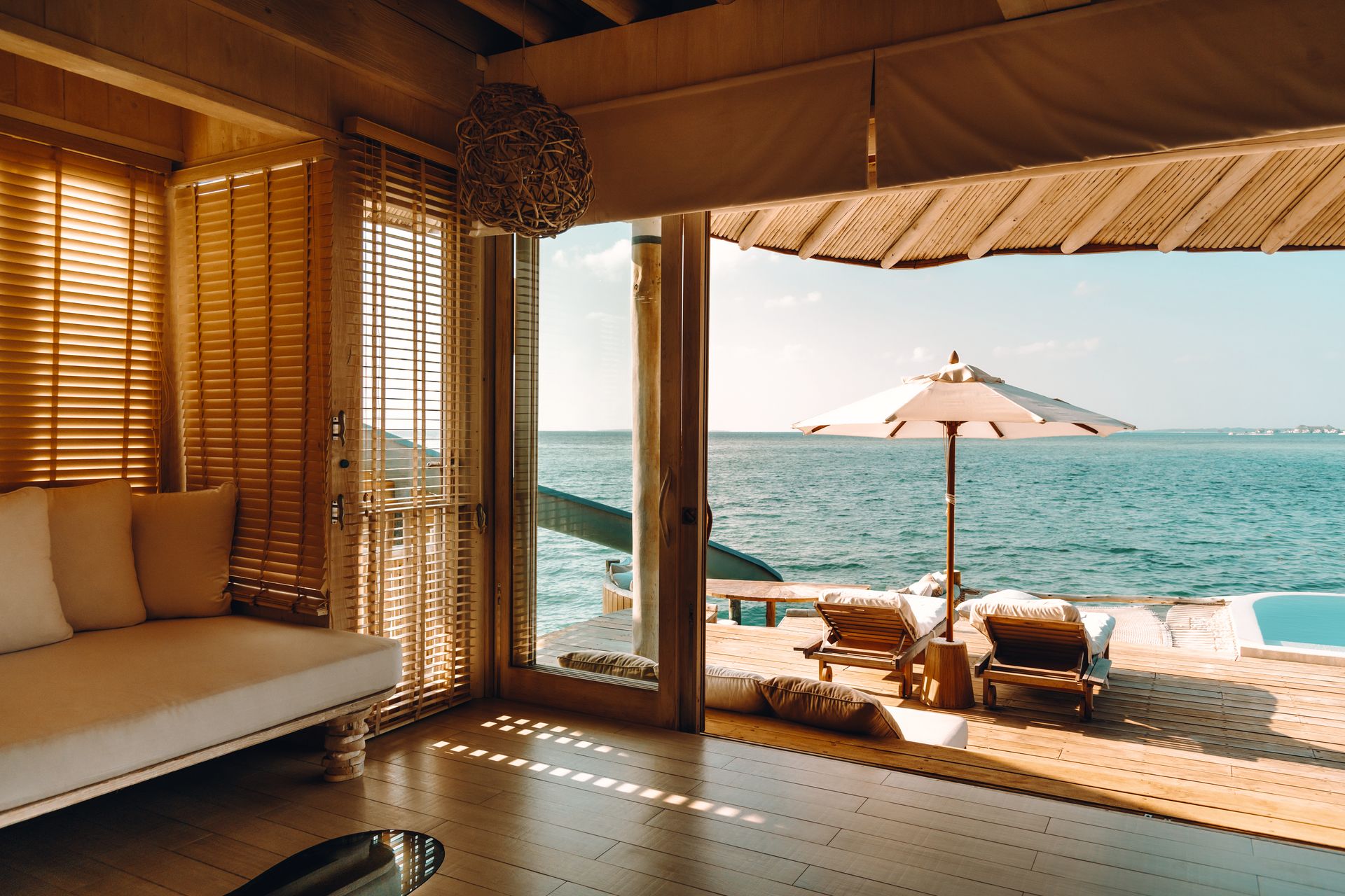 Water Retreat bedroom opening onto the lagoon terrace at Soneva Jani