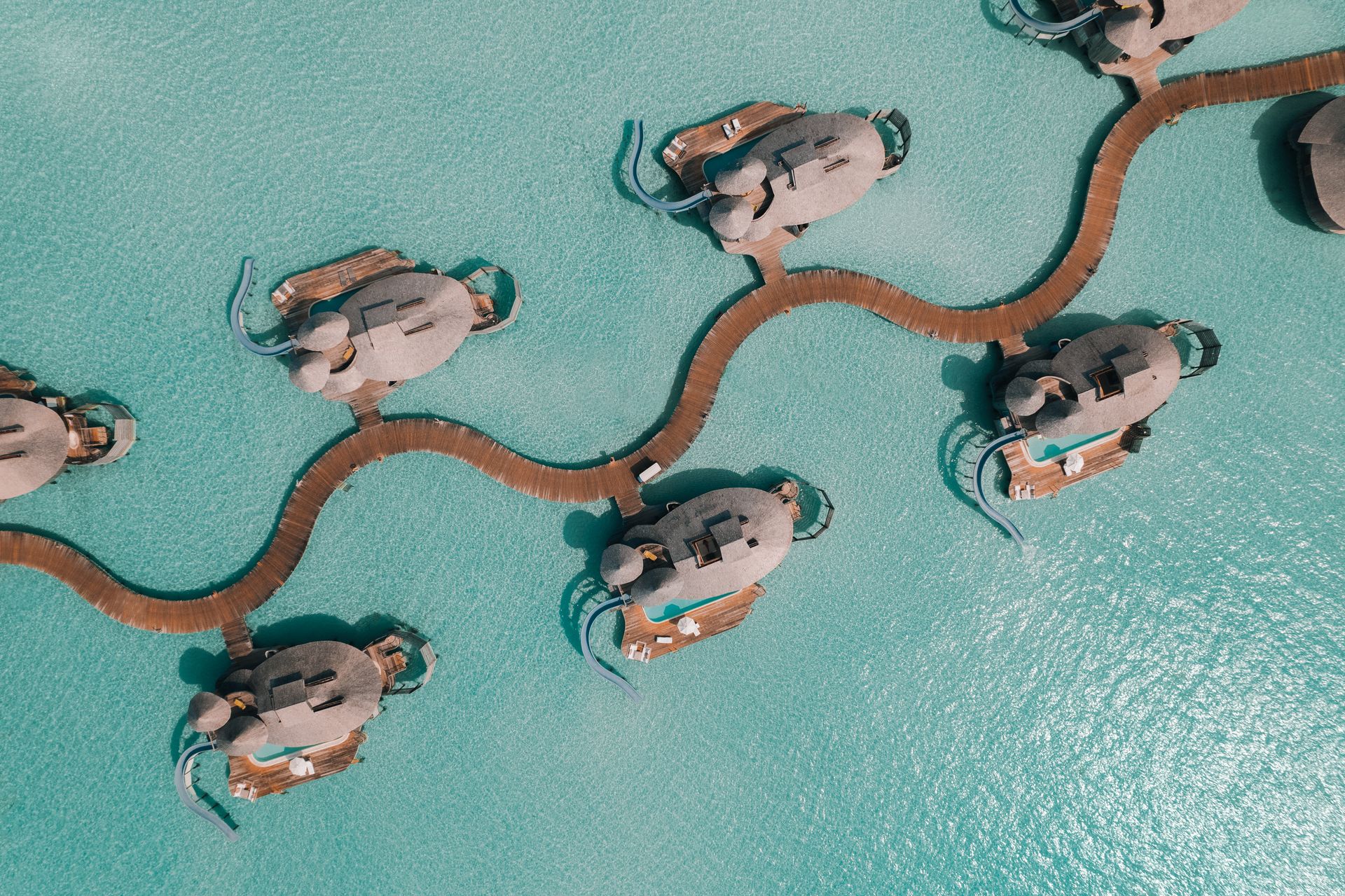 Water villas and winding jetty, overhead view at Soneva Jani