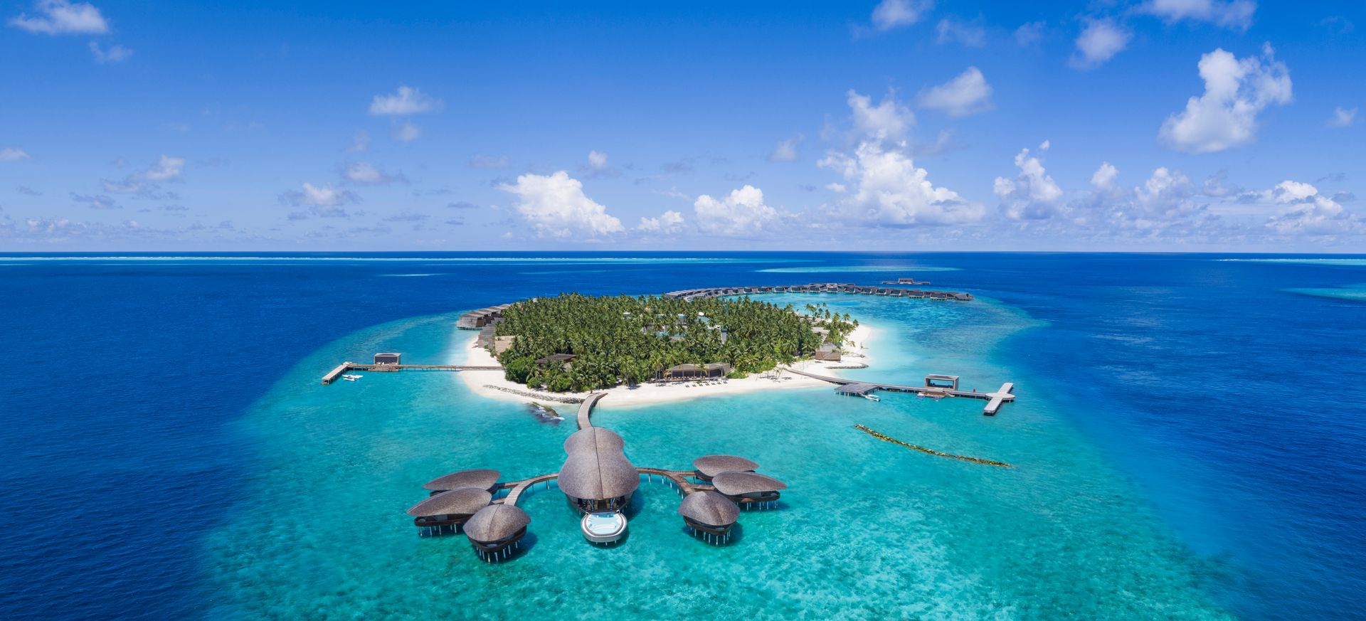 Island, reef and overwater spa, aerial view at The St. Regis Maldives Vommuli Resort