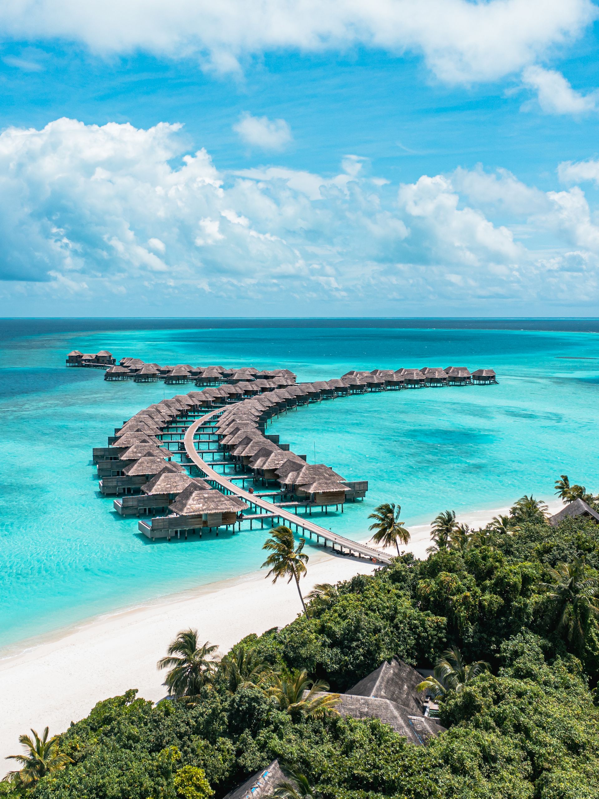 Curving jetty and water villas, aerial view at Vakkaru Maldives
